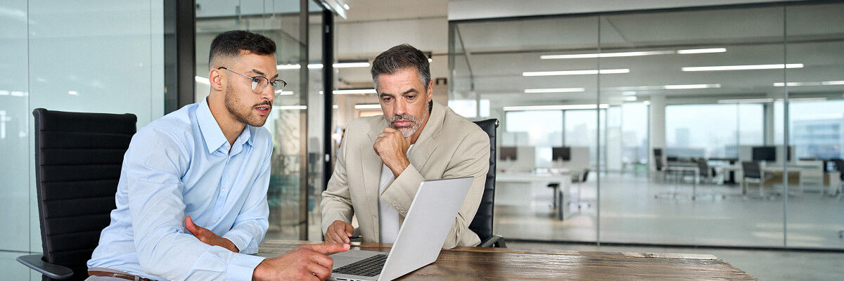 Stop Patching on a Schedule. Start Patching on the Clock. Man on laptop working.