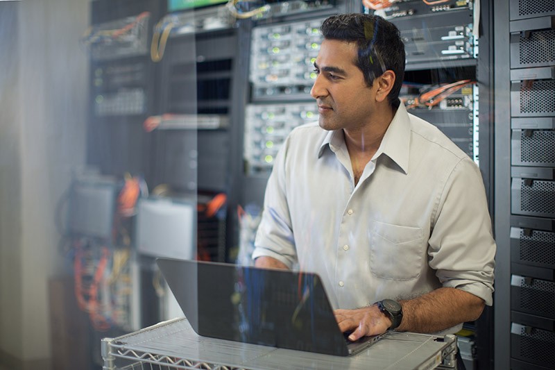 IT admin in data center using notebook computer