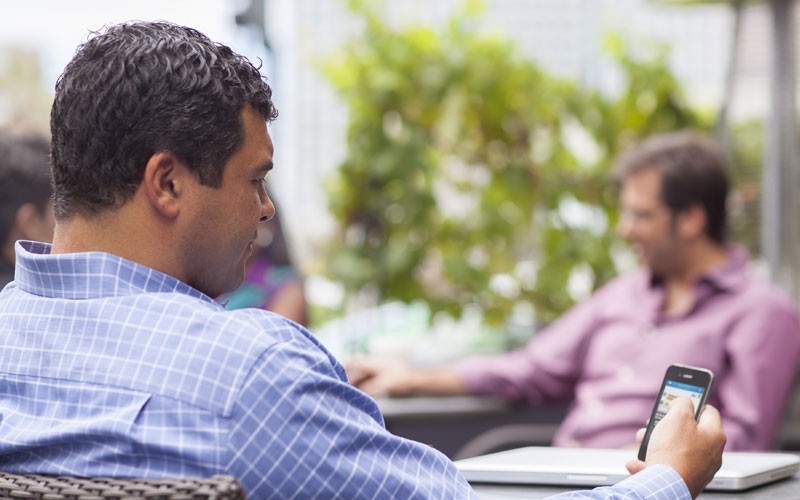 Business man outside using mobile device