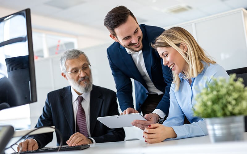 Professionals sharing ideas on a tablet