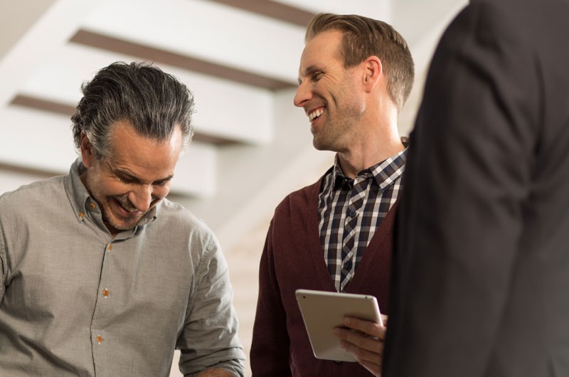 3 business men having cheerful conversation