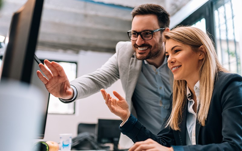 Man assisting female coworker