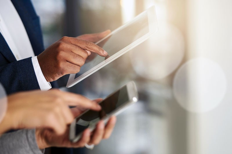 Tablet computer and smart phone in business persons hands