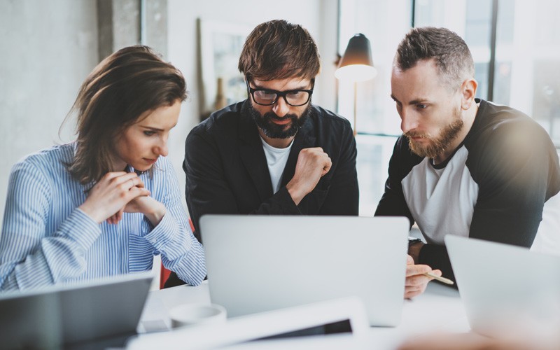 Users collaborating at laptop